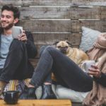 smiling sitting while drinking coffee