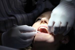 dentist checking patient teeth