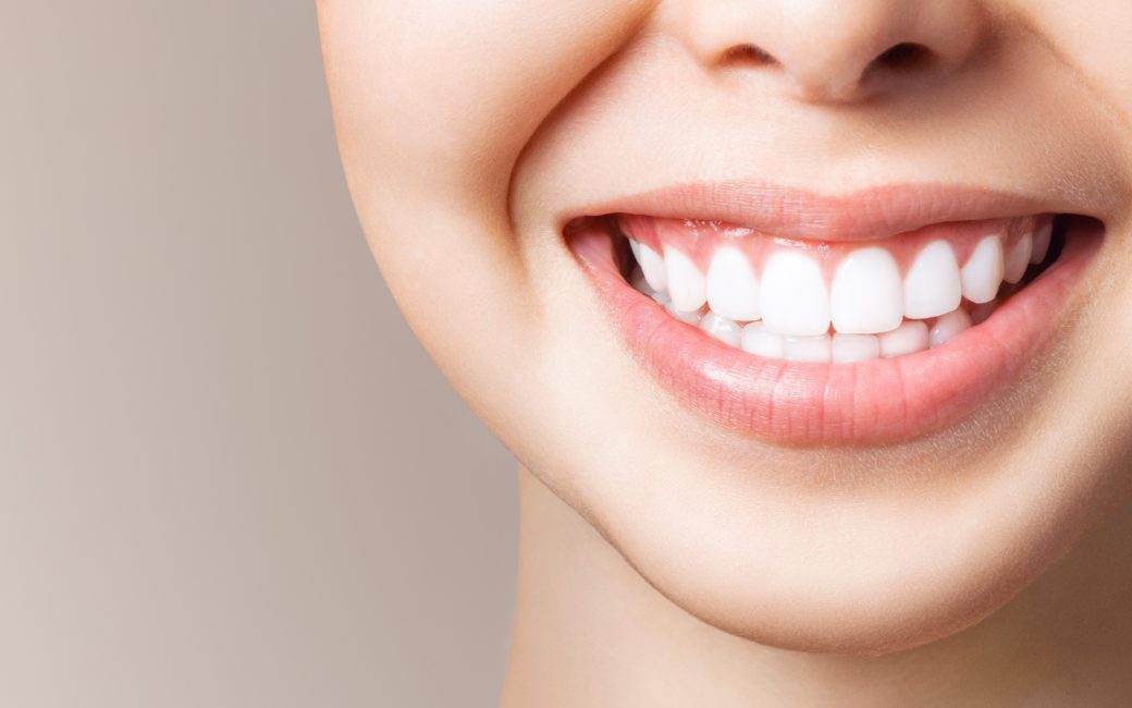 Perfect healthy teeth smile of a young woman. Teeth whitening. Dental clinic patient. Image symbolizes oral care dentistry, stomatology. Dentistry image.