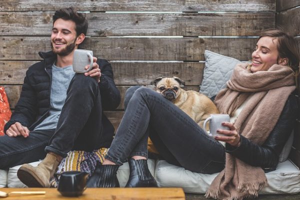 smiling sitting while drinking coffee